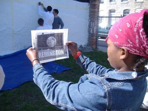painting the mural on 27th and Miles